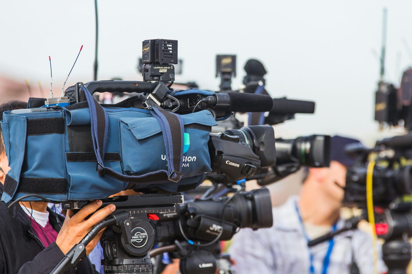 Journalist at a desk monitoring scanner radio feeds