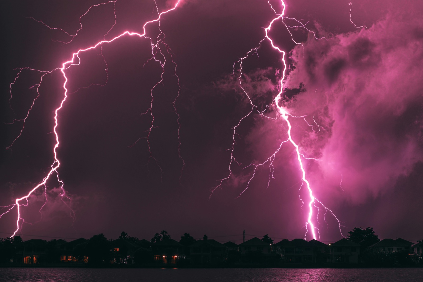 Lightning storm over a neighborhood at night